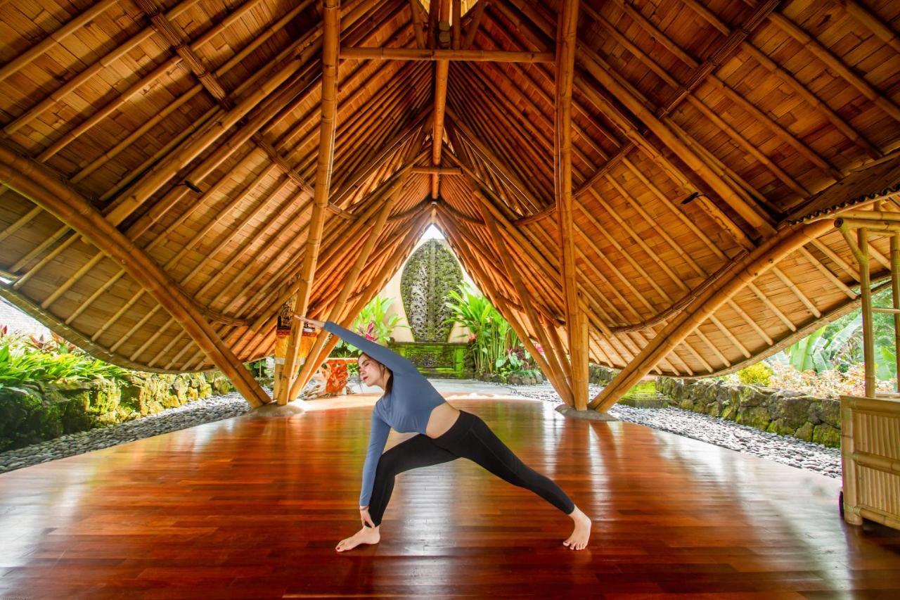 Weda Cita Resort And Spa By Mahaputra Ubud Exteriör bild A woman practicing yoga at the Four Seasons Resort Maui